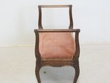 an image of a chair with a pink seat in a white room