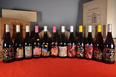 several bottles of wine are lined up on a table