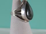 a close up of a ring with a black stone in it