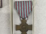 a small box with a medal and a book on the table