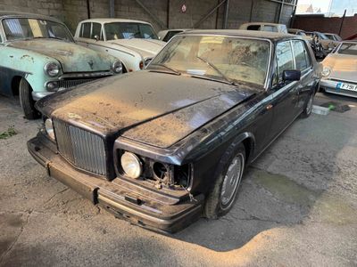 many old cars that are parked in a garage