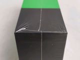 a close up of a green and black box on a white surface