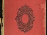 un vieux livre à la couverture rouge posé sur une surface noire