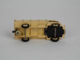 a yellow toy truck with black wheels on a white surface