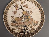 an image of a decorative plate with a bird and flowers on it