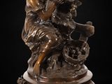 an antique bronze statue of a woman and child on a pedestal