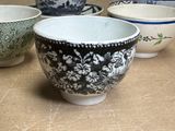 four bowls sitting on a table with one bowl in the middle