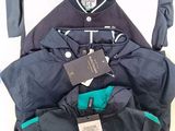 a pile of clothing that includes a jacket, jacket, and pants