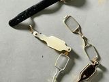 a watch, scissors, and other items that are on the table