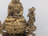 an image of a statue of a woman sitting on top of a bowl
