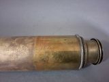 an old brass telescope with a metal case on a table