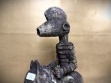 a statue of a dog that is sitting on top of a table