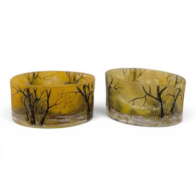 pair of yellow and black candles with trees on them on a white background