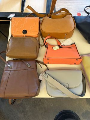 a lot of purses that are on a table