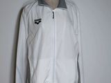 white jacket on a mannequin stand with a black and white logo