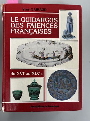 the book is sitting on a table next to a glass vase