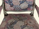 an image of a pink chair with a floral upholstered back