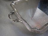 a silver tray with a mirror on it on a table