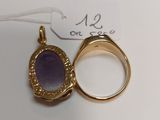 an image of a gold ring with a purple stone in it