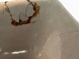 a dirty sink that has a hole in it