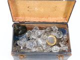 an open suitcase filled with glass items on a white surface