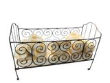 a metal basket with towels and towels in it