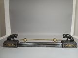 an image of a black and gold figurine of two lions on a shelf
