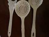 three spoons that are sitting on a table