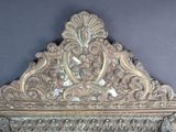 a large ornate mirror on the wall in the room