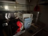a sink in a kitchen with a lot of clutter on it