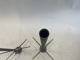 a pair of scissors and a pipe sitting on the floor