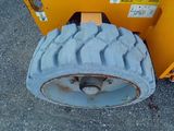 a large tire on the back of a construction vehicle