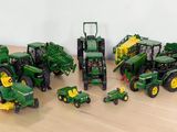 a lot of toy tractors that are sitting on a table