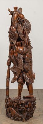 wooden statue of a man with a hat and a bird on his shoulder