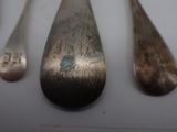 three spoons that are sitting next to each other on a table