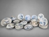 a lot of blue and white plates and bowls on the table