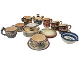 many cups and saucers that are sitting on the table