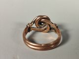a close up of a ring with a diamond in it