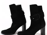 black sued ankle boots with a metal heel and buckles