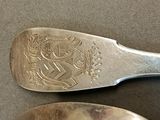two spoons that are sitting next to each other on a table