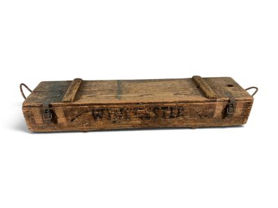 an old wooden box with writing on it sitting on a white surface