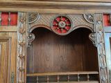 a wooden cabinet with a mirror on top of it