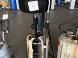 three different machines that are on display in a garage