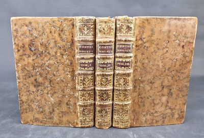 two old books sitting on top of each other on a table