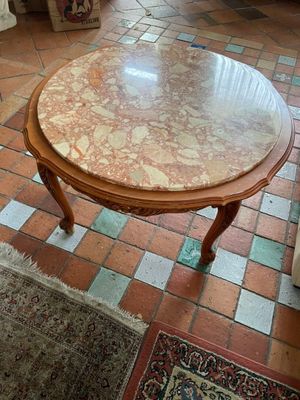 a table with a marble top in a living room