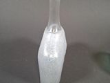 a glass bottle with a white substance inside of it