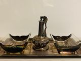 a silver tray with two bowls and a vase on it