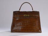 brown alligator skin handbag with gold hardware and strap
