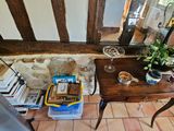 a small table with books and a glass of wine on it