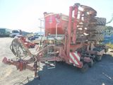 a large red machine that is parked on the side of the road